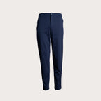 A pair of navy blue slim-fit trousers shown flat against a light beige background. 7 For All Mankind Trousers available at Sakks Menswear in Southampton.