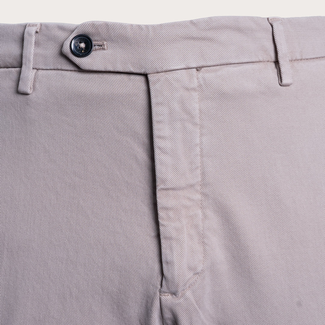 Close-up of the waistband of light gray trousers, showing the button closure, belt loops, and front seam. Briglia 1949 Trousers available at Sakks Menswear in Southampton.