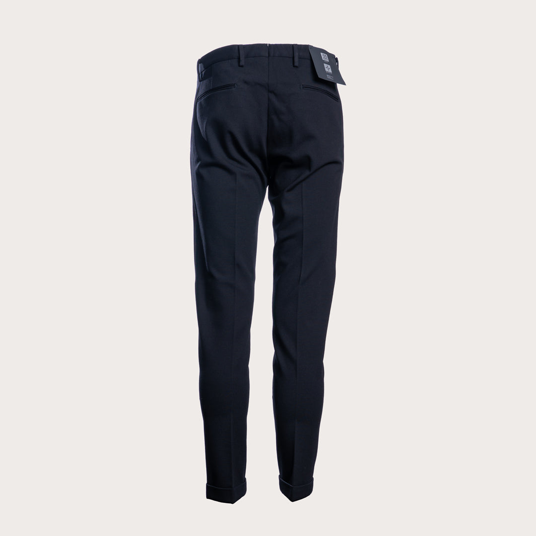 A pair of dark navy trousers shown from the back, featuring a slim fit and a small brand patch near the waistband, set against a solid light gray background. Briglia 1949 Trousers available at Sakks Menswear in Southampton.