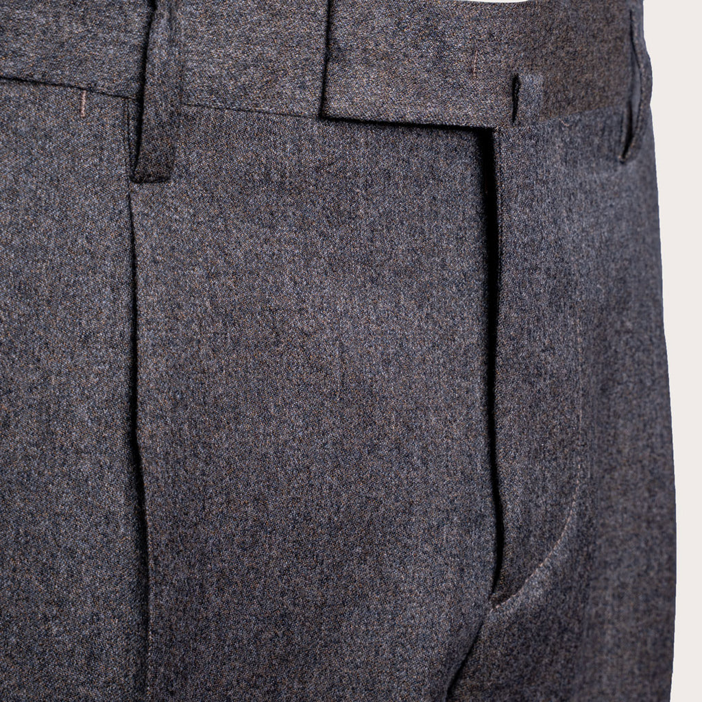 Close-up of dark gray textured wool trousers showing the fabric weave, belt loops, and front crease. Briglia 1949 Trousers available at Sakks Menswear in Southampton.