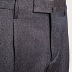 Close-up of dark gray textured wool trousers showing the fabric weave, belt loops, and front crease. Briglia 1949 Trousers available at Sakks Menswear in Southampton.
