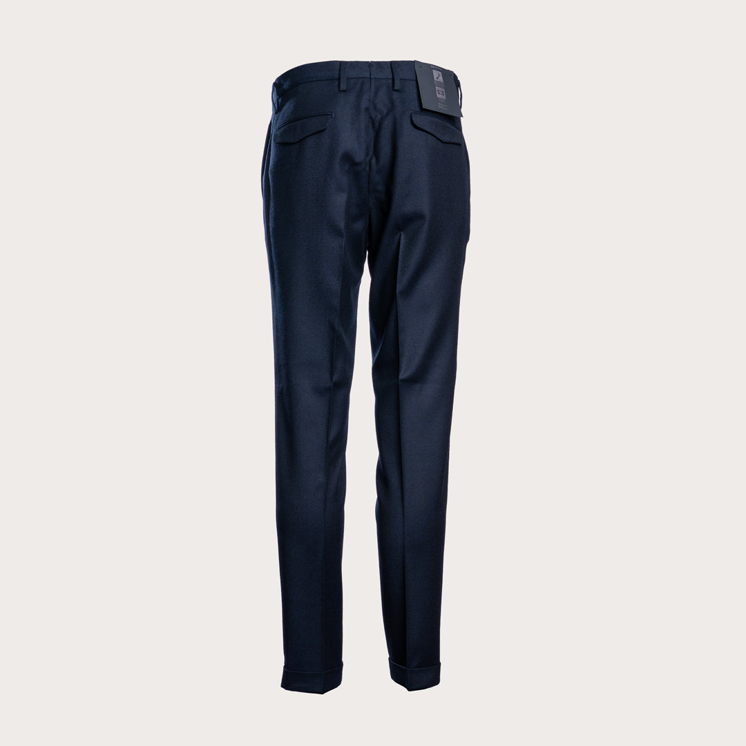 A pair of dark navy blue trousers shown from the back, featuring a clean waistband, belt loops, and two rear patch pockets, set against a solid light gray background. Briglia 1949 Trousers available at Sakks Menswear in Southampton.