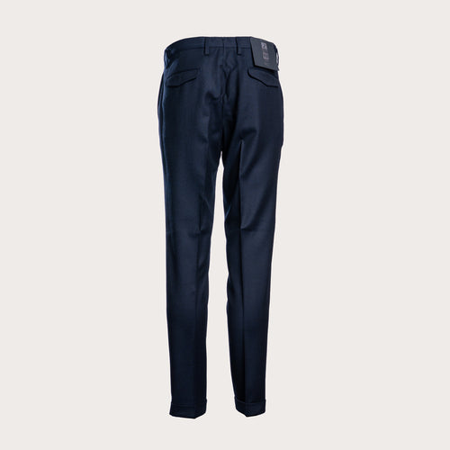 A pair of dark navy blue trousers shown from the back, featuring a clean waistband, belt loops, and two rear patch pockets, set against a solid light gray background. Briglia 1949 Trousers available at Sakks Menswear in Southampton.