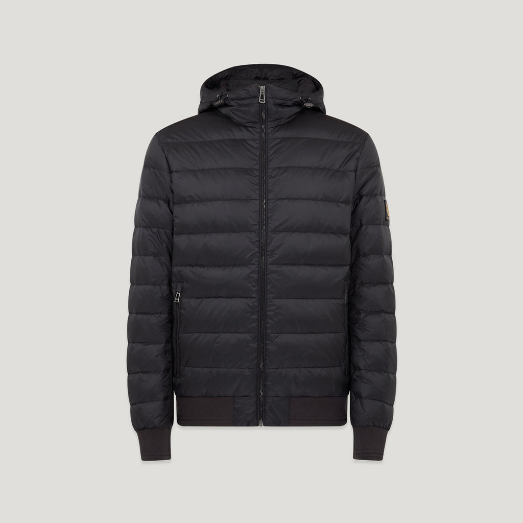A black hooded puffer jacket with horizontal quilting, a full front zipper, ribbed cuffs and hem, and a small tan brand patch on the left sleeve, shown against a light grey background. Belstaff Down Jacket. Sakks Menswear Southampton.