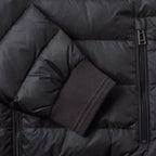 Close-up of a black puffer jacket showing quilted padding, a side zipper, and a ribbed dark cuff. Belstaff Down Jacket. Sakks Menswear Southampton.