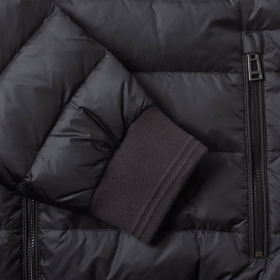 Close-up of a black puffer jacket showing quilted padding, a side zipper, and a ribbed dark cuff. Belstaff Down Jacket. Sakks Menswear Southampton.