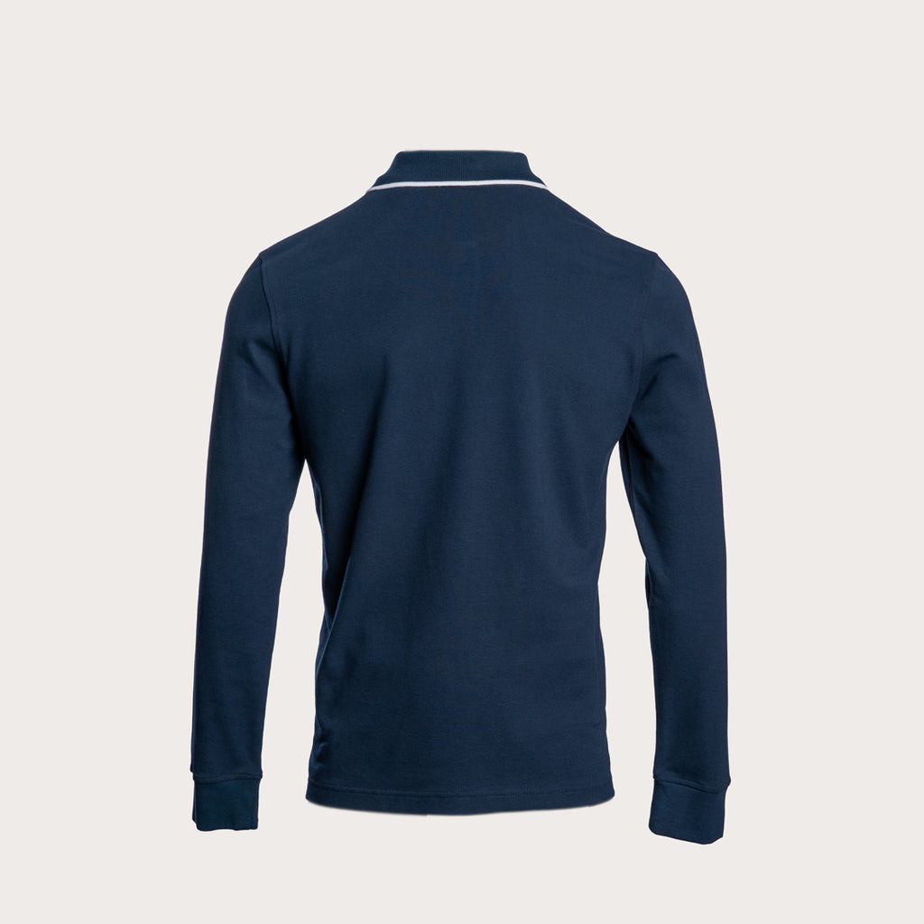 A navy blue long-sleeve polo shirt shown from the back, featuring a thin white stripe detail along the collar, set against a solid light beige background. Belstaff Long Sleeved Polo. Sakks Menswear Southampton.