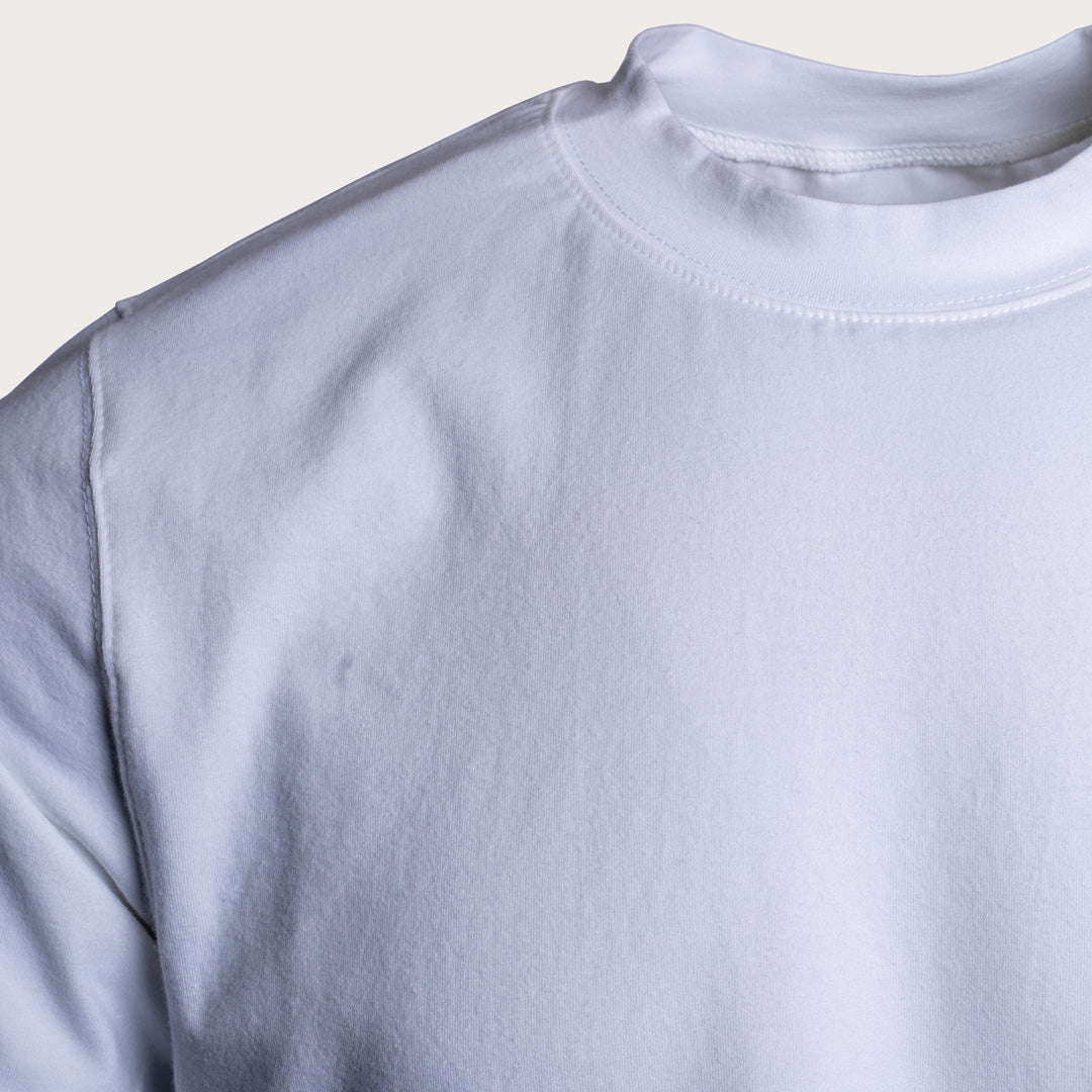 Close-up of a plain white crewneck sweatshirt showing the collar, shoulder seam, and soft fabric texture against a light beige background. Circolo 1901 T-Shirt available at Sakks Menswear in Southampton.