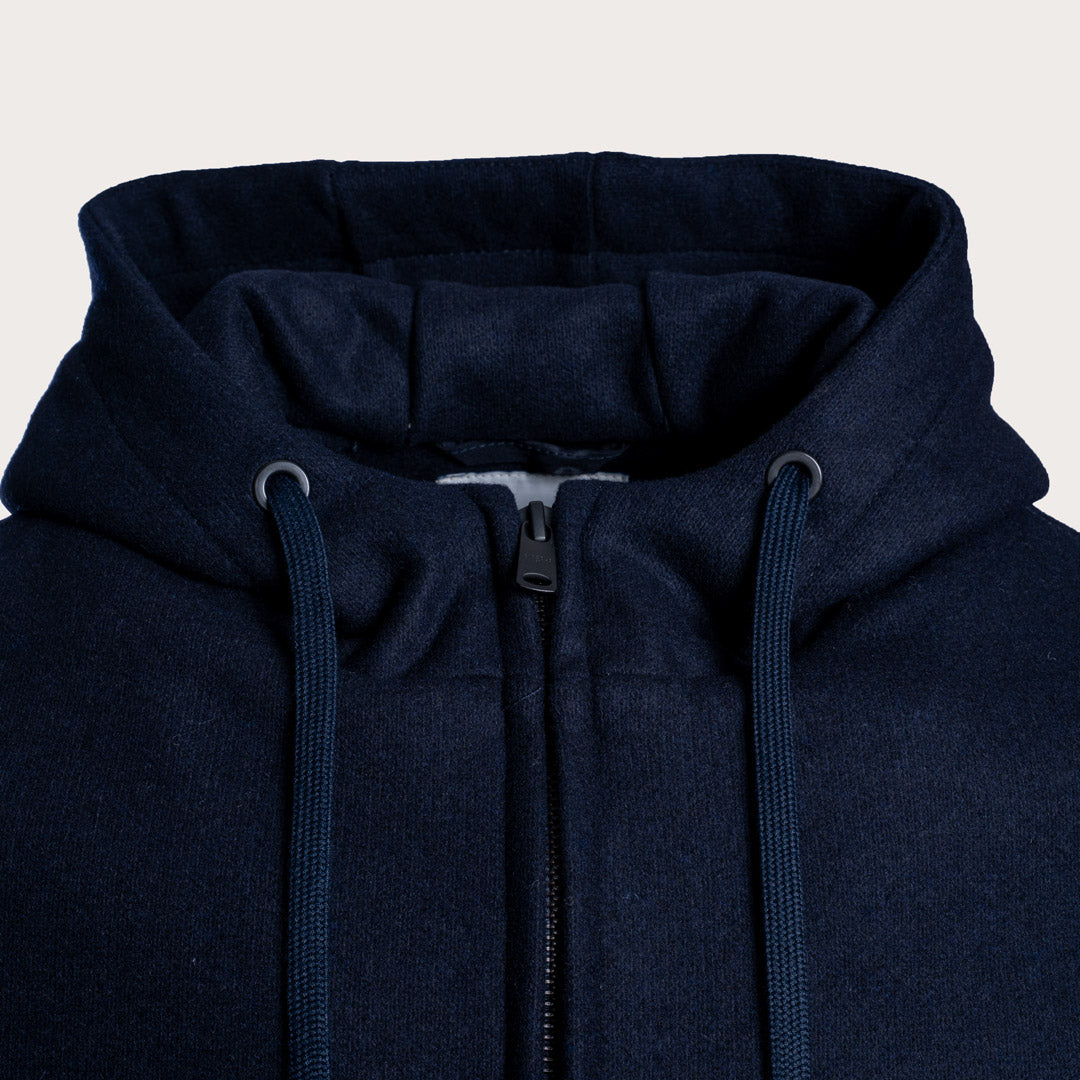 Close-up of a navy blue zip-up hoodie showing the hood, drawstrings, and front zipper against a light off-white background. Circolo 1901 Hoodie available at Sakks Menswear in Southampton.