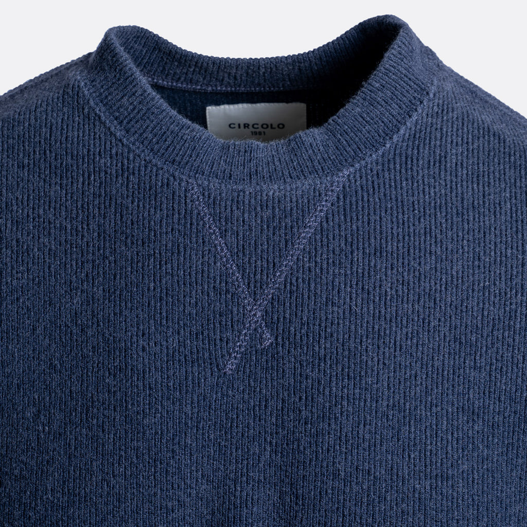 Close-up of a navy blue knit crewneck sweater with a visible neck label reading CIRCOLO. Circolo 1901 Jumper available at Sakks Menswear in Southampton.