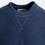 Close-up of a navy blue knit crewneck sweater with a visible neck label reading CIRCOLO. Circolo 1901 Jumper available at Sakks Menswear in Southampton.