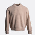A light beige crewneck sweatshirt with a fine ribbed texture, shown against a plain light gray background. Circolo 1901 Jumper available at Sakks Menswear in Southampton.