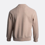 A light beige ribbed knit sweater shown from the back, featuring a crew neck, long sleeves, and ribbed cuffs and hem, set against a plain light gray background. Circolo 1901 Jumper available at Sakks Menswear in Southampton.