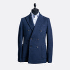 A men's double-breasted blazer in textured navy blue, displayed on a black mannequin torso with a light blue dress shirt underneath, set against a plain light gray background. Circolo 1901 Blazer available at Sakks Menswear in Southampton.