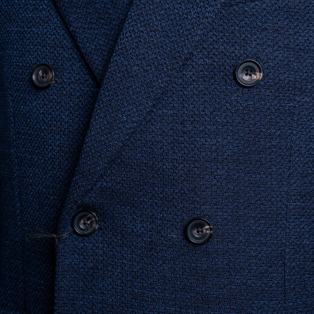 Close-up of a textured navy blue double-breasted suit jacket, showing the fabric weave and dark buttons. Circolo 1901 Blazer available at Sakks Menswear in Southampton.