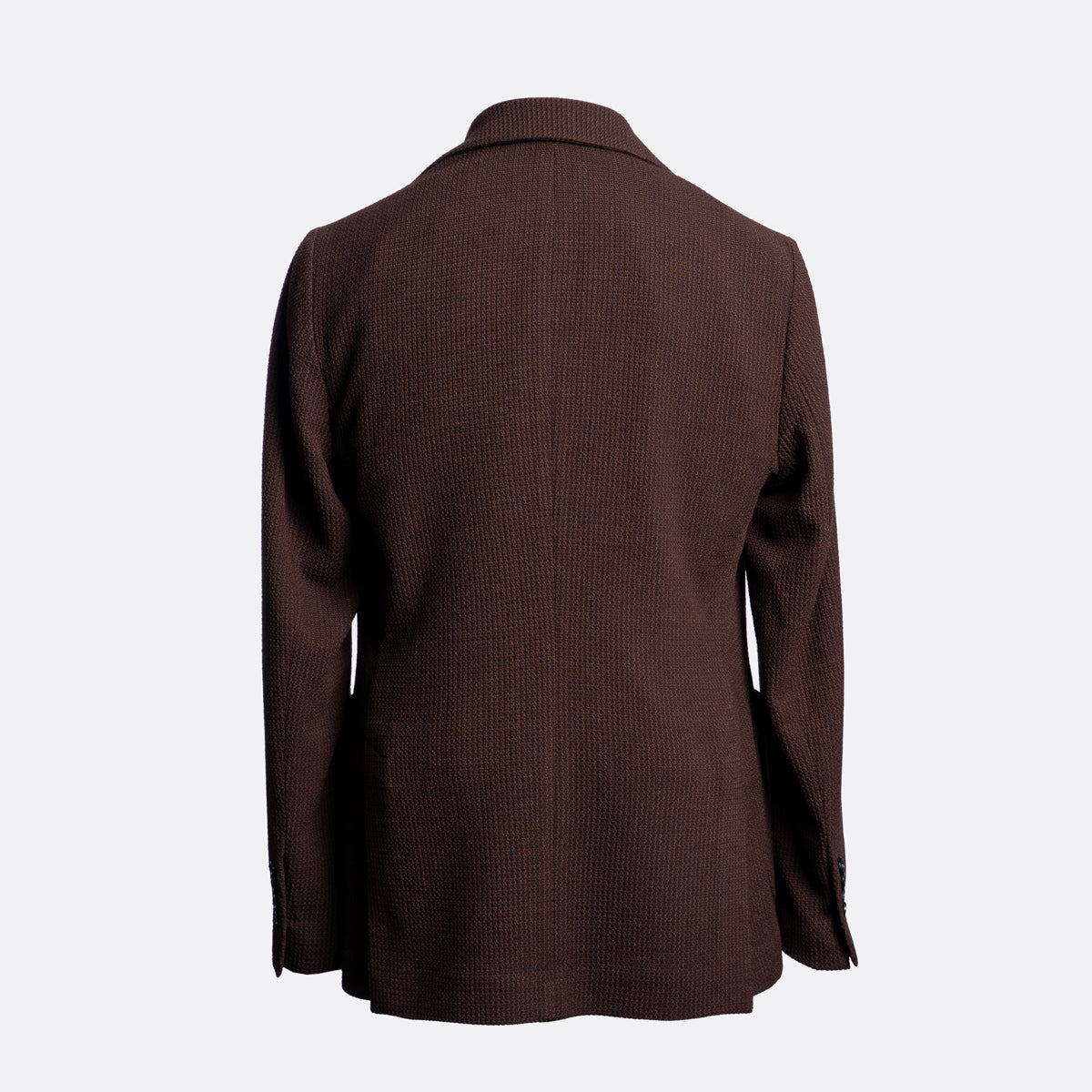 A dark brown textured blazer shown from the back, featuring a subtle vertical rib pattern and notch lapels, set against a plain light gray background. Circolo 1901 Blazer available at Sakks Menswear in Southampton.