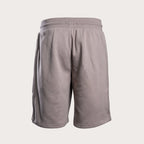 A pair of light taupe gray athletic shorts with a ribbed elastic waistband, shown from the back on a light beige background. Emporio Armani Sweat Shorts. Sakks Menswear Southampton.