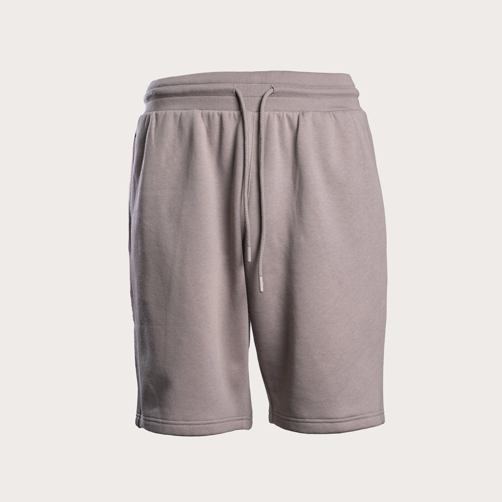 A pair of light gray sweat shorts with an elastic waistband and a matching drawstring, shown against a solid off-white background. Emporio Armani Sweat Shorts. Sakks Menswear Southampton.