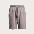 A pair of light gray sweat shorts with an elastic waistband and a matching drawstring, shown against a solid off-white background. Emporio Armani Sweat Shorts. Sakks Menswear Southampton.