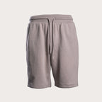 A pair of light gray sweat shorts with an elastic waistband and a matching drawstring, shown against a solid off-white background. Emporio Armani Sweat Shorts. Sakks Menswear Southampton.