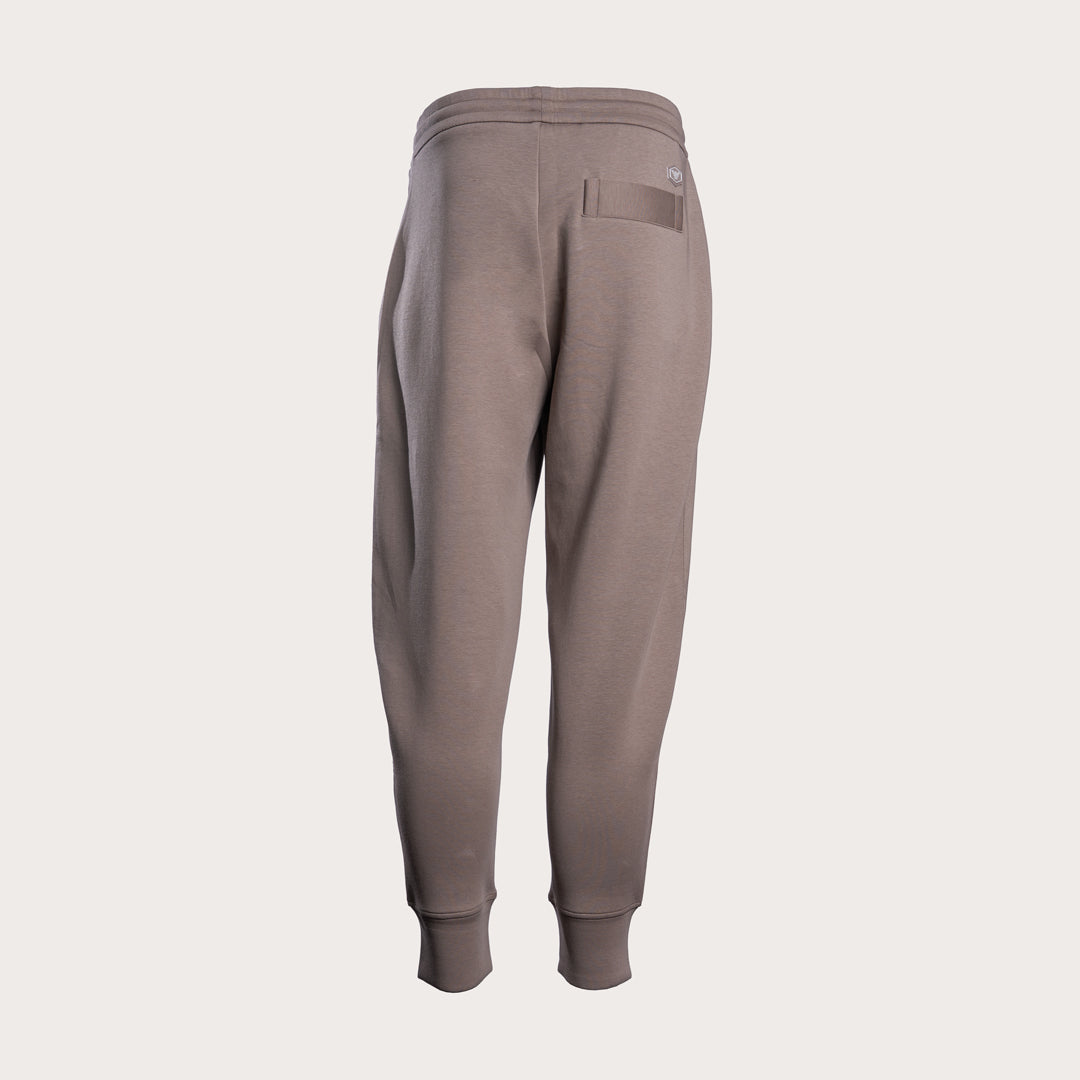 A pair of jogger sweatpants in a muted taupe-brown color, shown from the back on a light gray background. Emporio Armani Sweat Pants. Sakks Menswear Southampton.