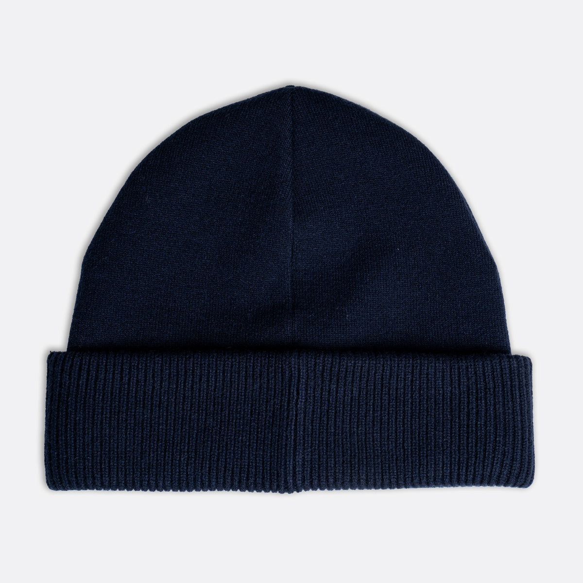 A dark navy blue knit beanie hat with a folded cuff, shown flat against a light gray background. Emporio Armani Beanie. Sakks Menswear Southampton.