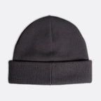 A dark gray ribbed knit beanie hat shown flat against a light gray background. Emporio Armani Beanie. Sakks Menswear Southampton.