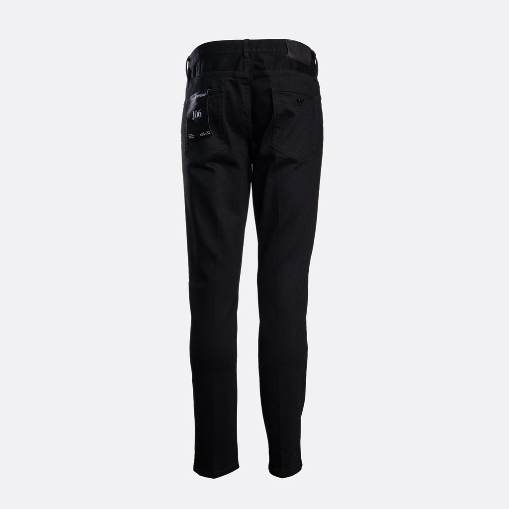 Black slim-fit jeans shown from the back, featuring a button closure and a small embroidered logo on the back pocket, set against a plain light gray background. Emporio Armani Jeans. Sakks Menswear Southampton.