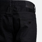 Close-up of the back waistband and right rear pocket of black Emporio Armani jeans, showing the brand patch and logo. Emporio Armani Jeans. Sakks Menswear Southampton.
