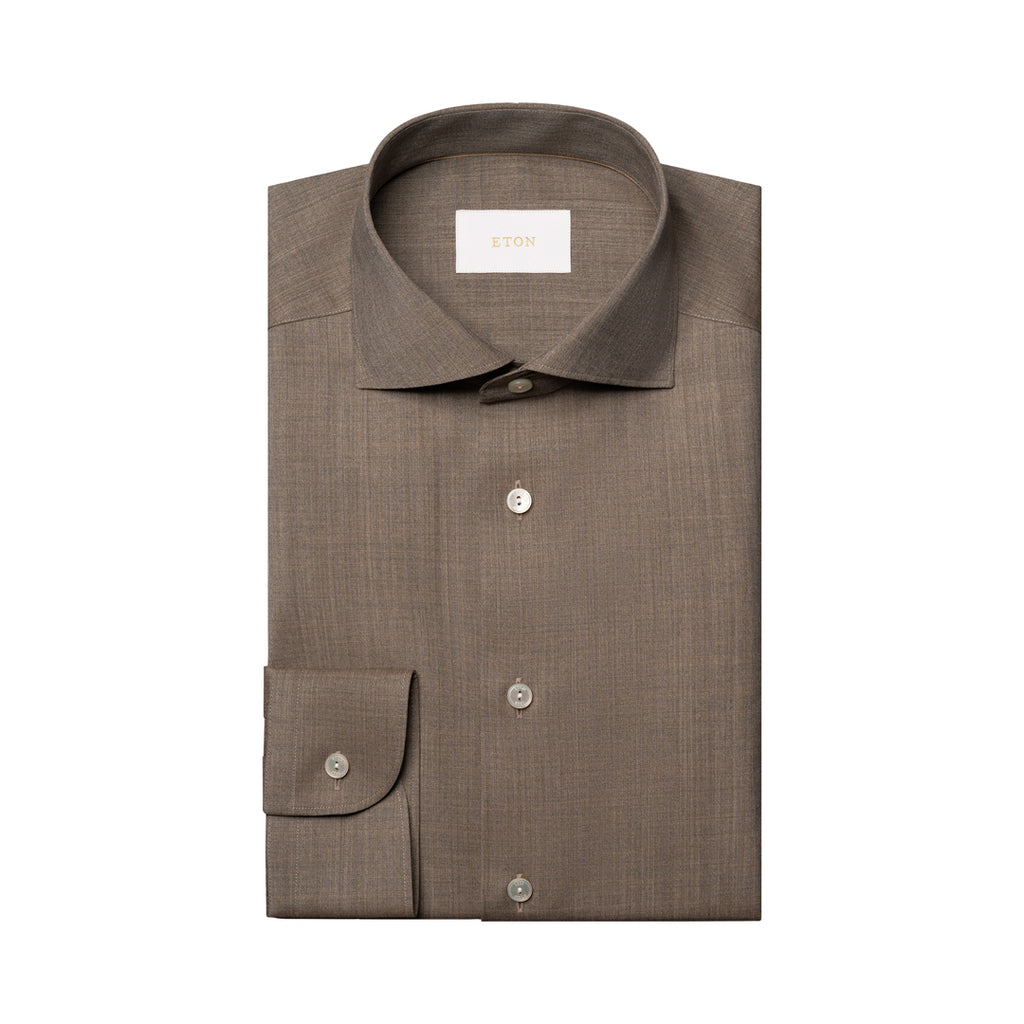 A folded brown dress shirt with a spread collar and button-down front, displayed on a clean white background. Eton Shirt available at Sakks Menswear in Southampton.