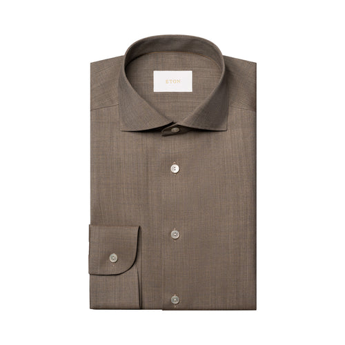 A folded brown dress shirt with a spread collar and button-down front, displayed on a clean white background. Eton Shirt available at Sakks Menswear in Southampton.