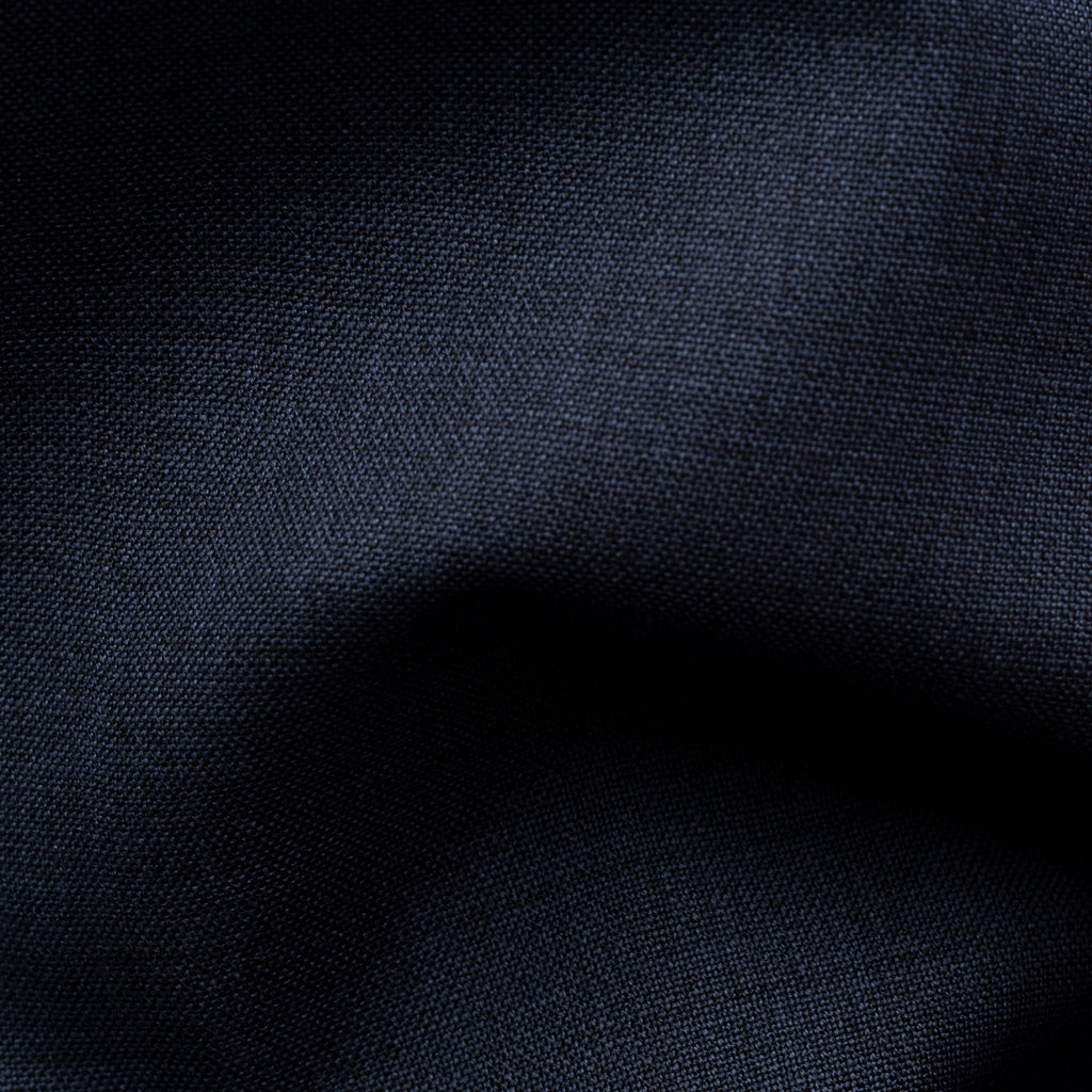 A close-up of dark navy blue fabric with a visible woven texture and soft folds. Eton Shirt available at Sakks Menswear in Southampton.