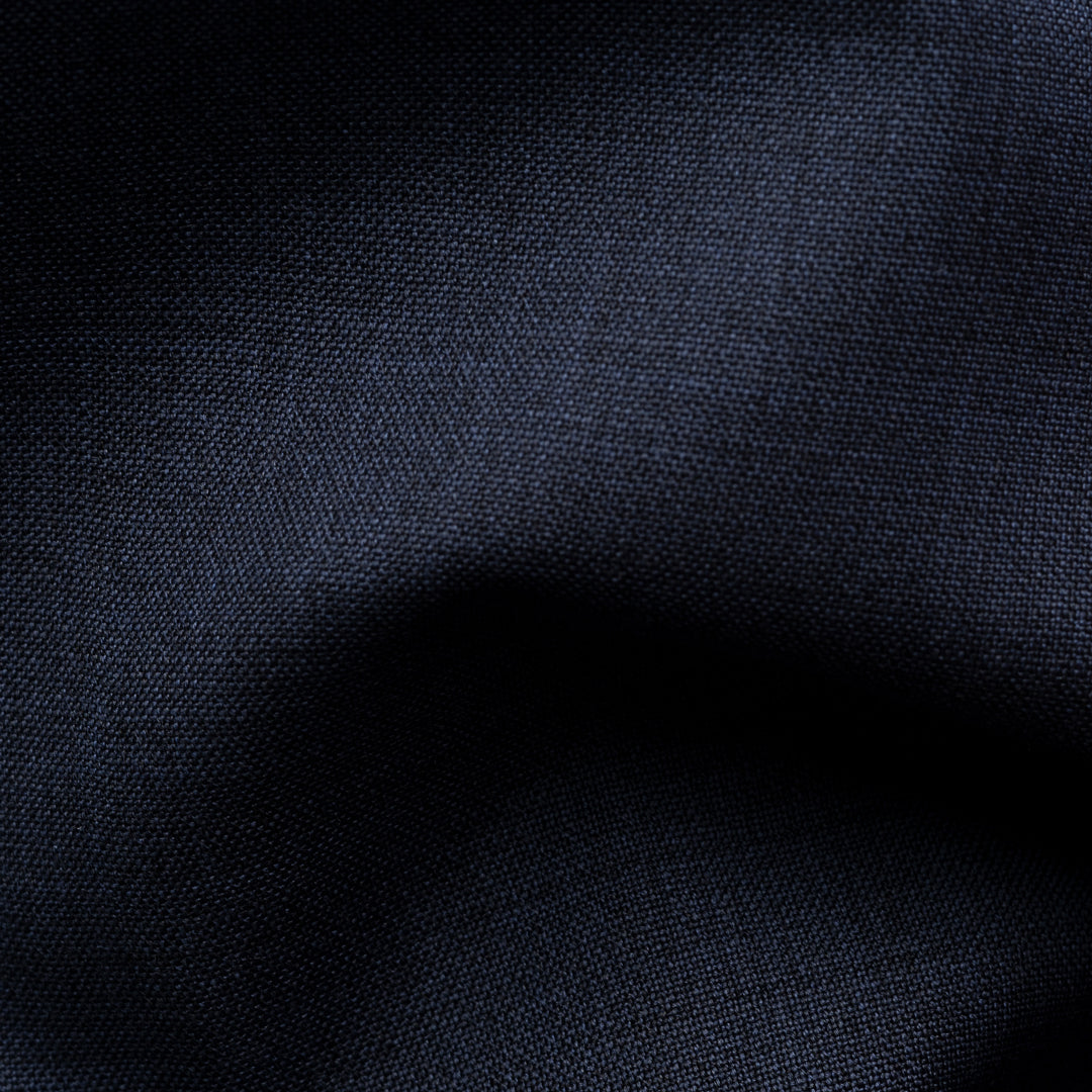 A close-up of dark navy blue fabric with a visible woven texture and soft folds. Eton Shirt available at Sakks Menswear in Southampton.