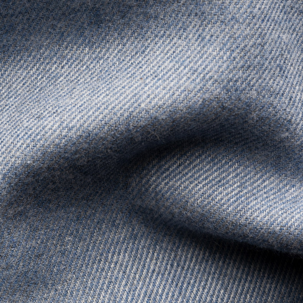 A close-up of textured blue fabric with a fine woven pattern and soft folds. Eton Shirt available at Sakks Menswear in Southampton.