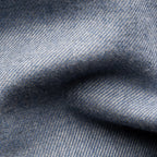 A close-up of textured blue fabric with a fine woven pattern and soft folds. Eton Shirt available at Sakks Menswear in Southampton.