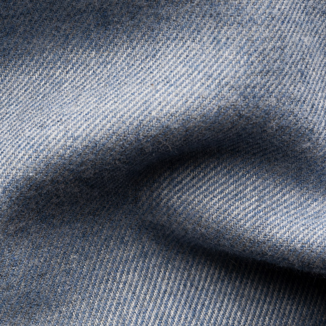 A close-up of textured blue fabric with a fine woven pattern and soft folds. Eton Shirt available at Sakks Menswear in Southampton.