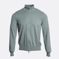 A light sage green knit zip-up jacket with a mock neck collar, shown on a clean, light grey background. Gran Sasso Knitwear available at Sakks Menswear in Southampton.