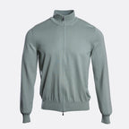 A light sage green knit zip-up jacket with a mock neck collar, shown on a clean, light grey background. Gran Sasso Knitwear available at Sakks Menswear in Southampton.