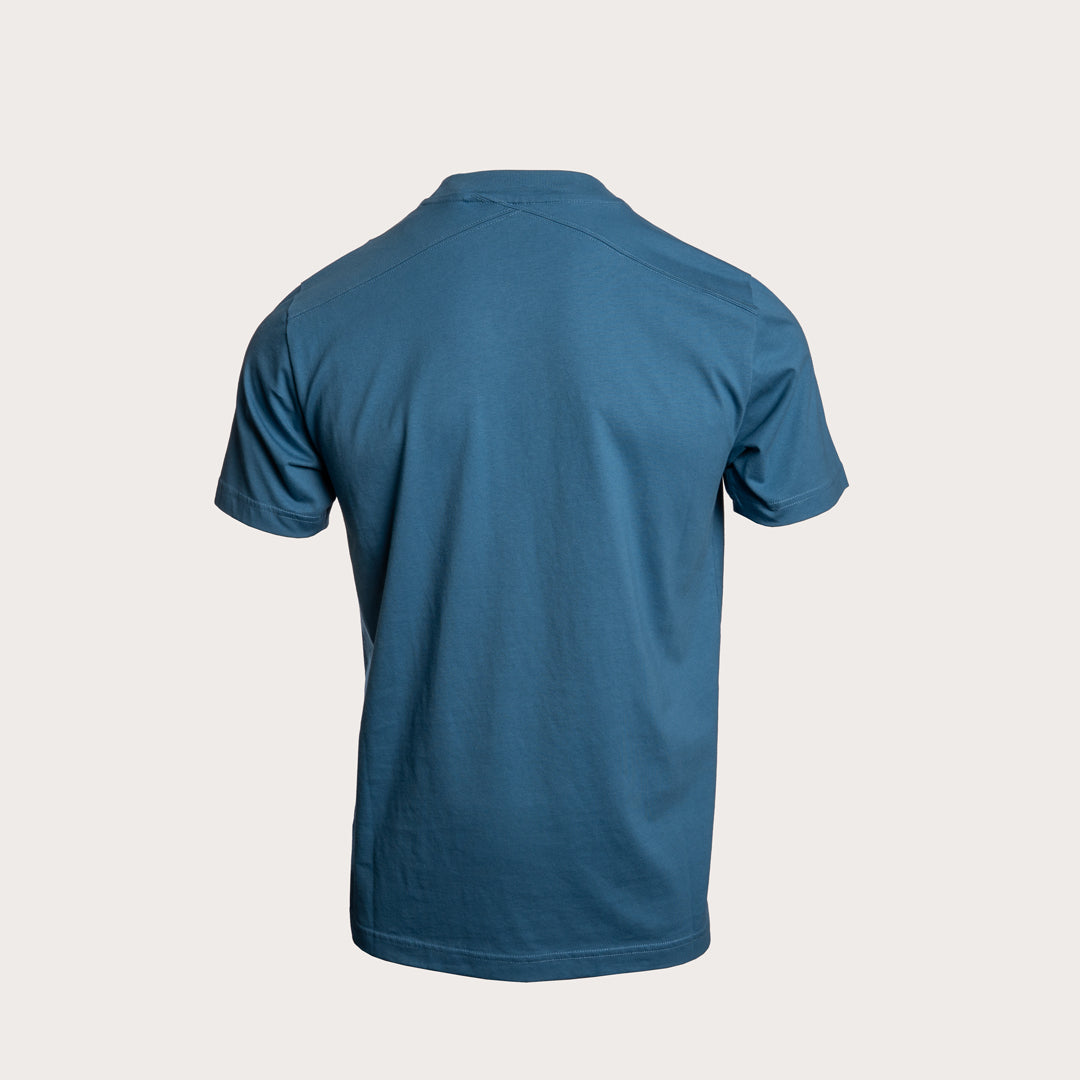 A short-sleeve crewneck t-shirt shown from the back, in a solid teal blue color, displayed on a light beige background. MA.Strum T-Shirt available at Sakks Menswear in Southampton.