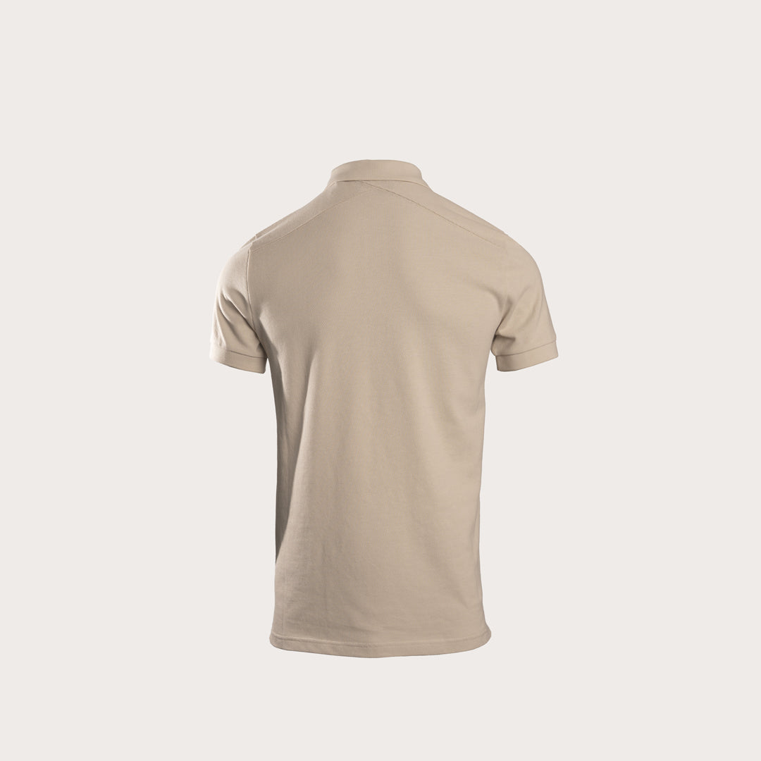 A short-sleeve polo shirt shown from the back, in a solid light beige color, displayed on a clean, solid off-white background. MA.Strum Polo available at Sakks Menswear in Southampton.