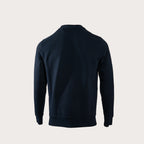 A dark navy blue long-sleeve crewneck sweatshirt shown from the back, photographed on a clean, solid light beige background. MA.Strum Sweatshirt available at Sakks Menswear in Southampton.