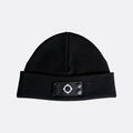 A black knit beanie hat with a folded cuff featuring a black rectangular patch with a white geometric target logo and four snap buttons. MA.Strum Beanie available at Sakks Menswear in Southampton.