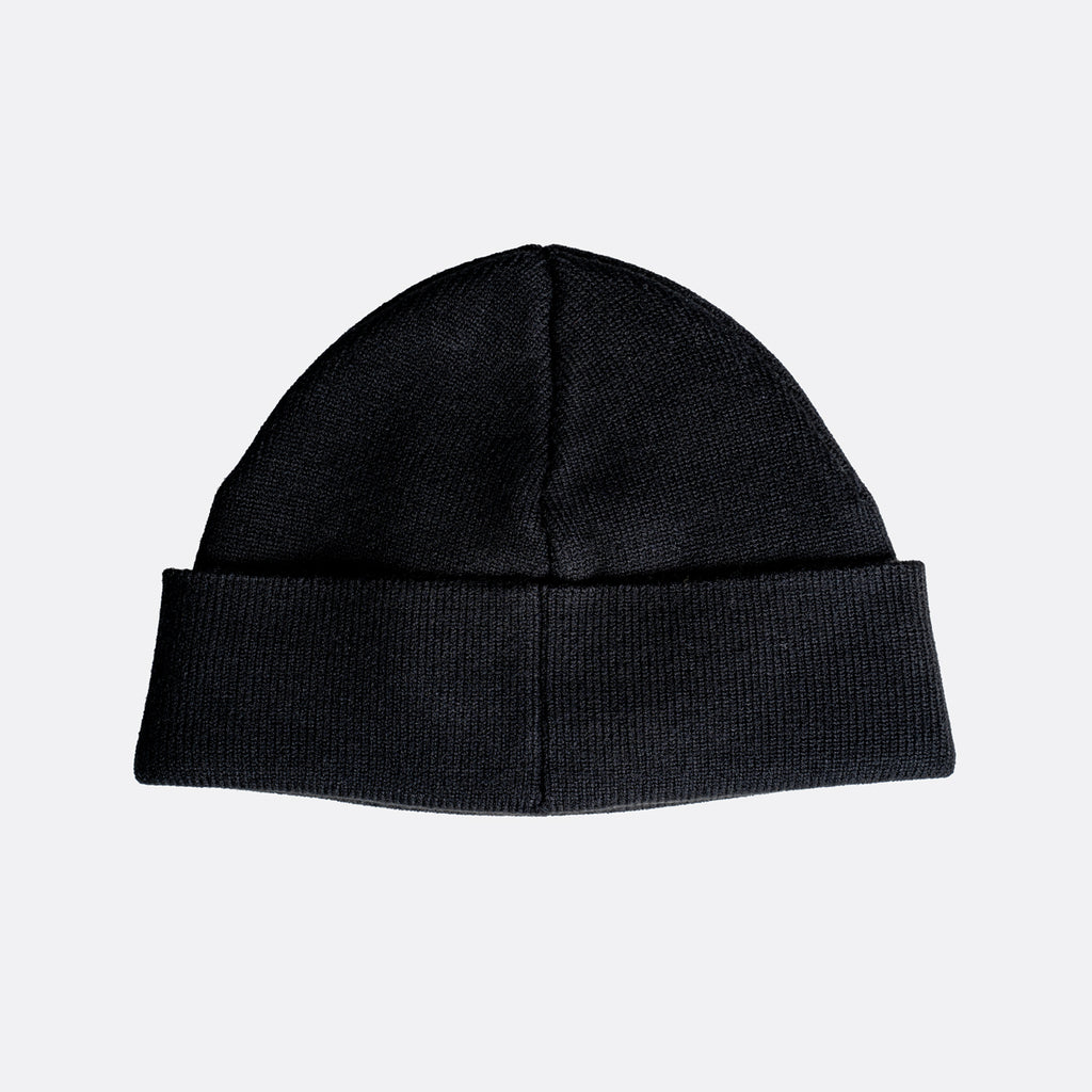 A black ribbed knit beanie hat with a folded cuff, shown against a plain light gray background. MA.Strum Beanie available at Sakks Menswear in Southampton.