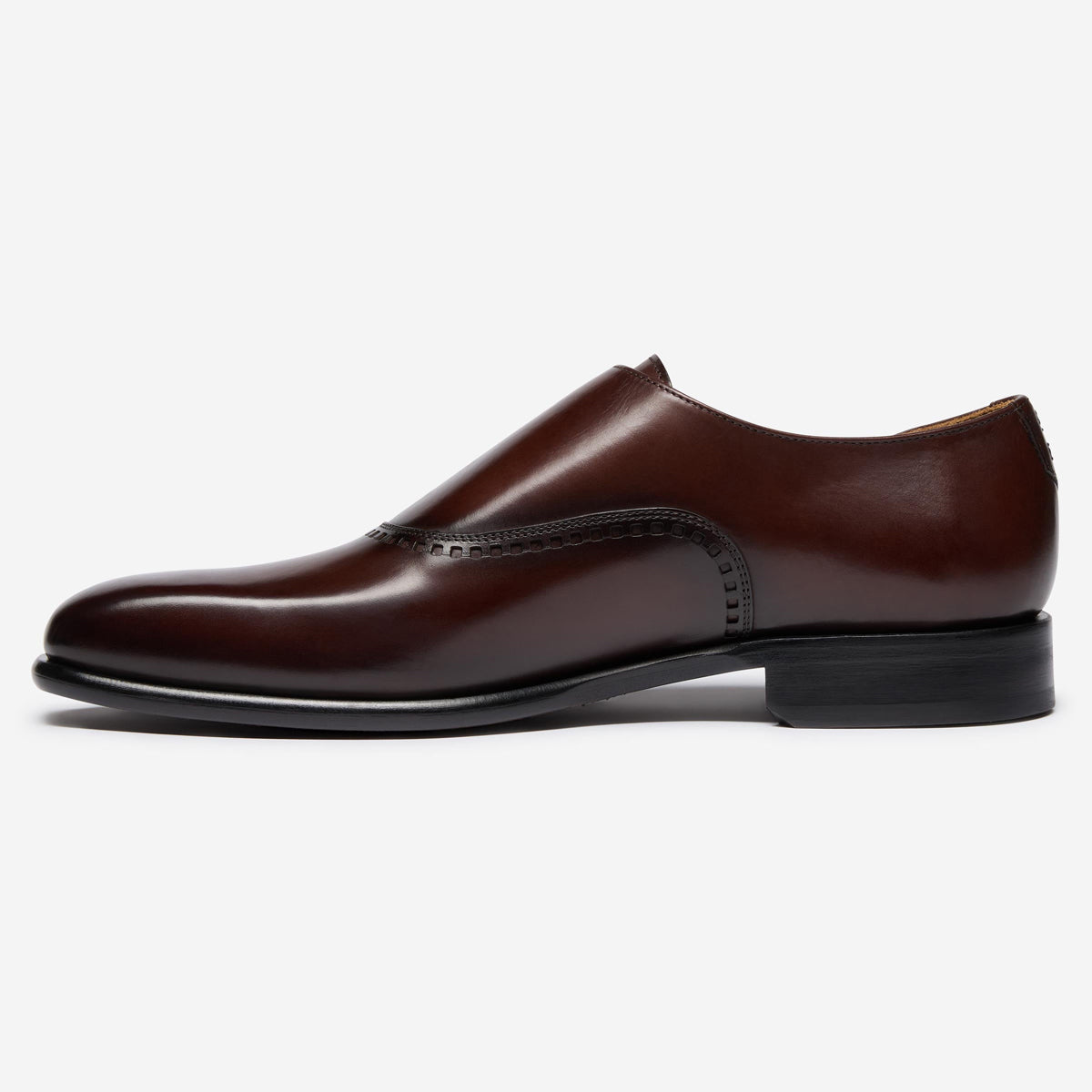 A single dark brown leather dress shoe with a wingtip brogue and black sole, shown in a side profile on a light gray background. Oliver Sweeney Shoes available at Sakks Menswear in Southampton.