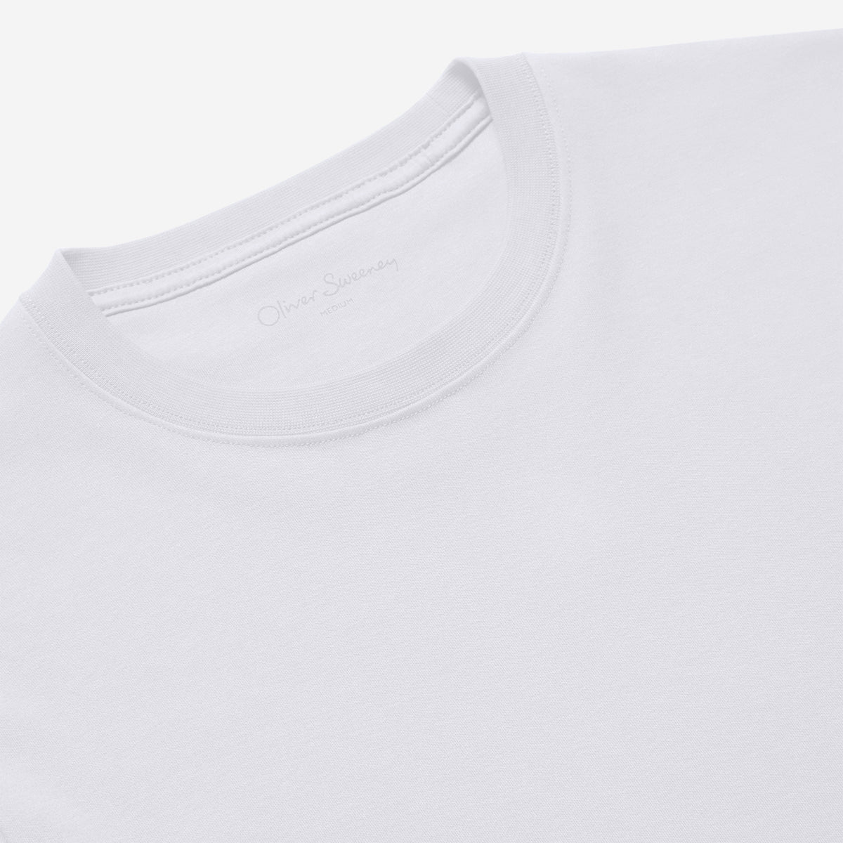 Close-up of a white crew-neck t-shirt showing the inner neck label with 'Oliver Sacksaby' printed in gray. Oliver Sweeney T-Shirt available at Sakks Menswear in Southampton.
