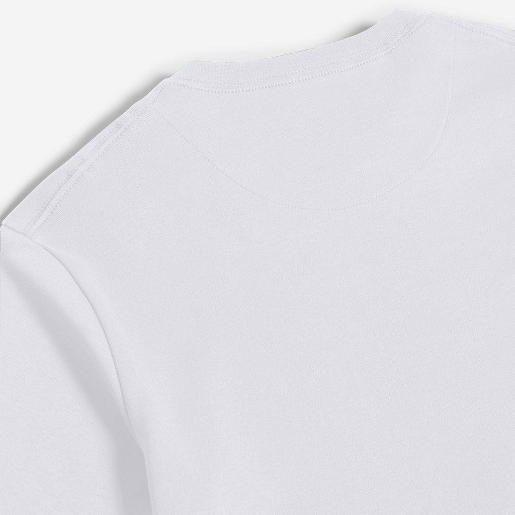 Close-up of a plain white long-sleeve top showing the shoulder seam and neckline stitching against a light gray background. Oliver Sweeney T-Shirt available at Sakks Menswear in Southampton.