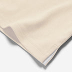 Beige quilted blanket on a white background. Oliver Sweeney T-Shirt available at Sakks Menswear in Southampton