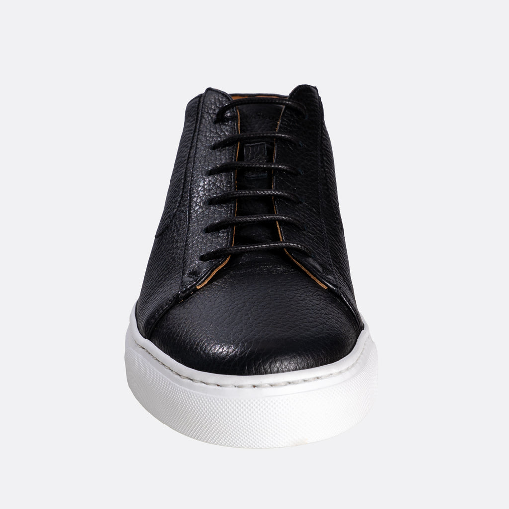 A black leather lace-up sneaker with a textured grain finish, black laces, and a thick white rubber sole, shown from a front-facing perspective on a light gray background. Oliver Sweeney Sneakers available at Sakks Menswear in Southampton.