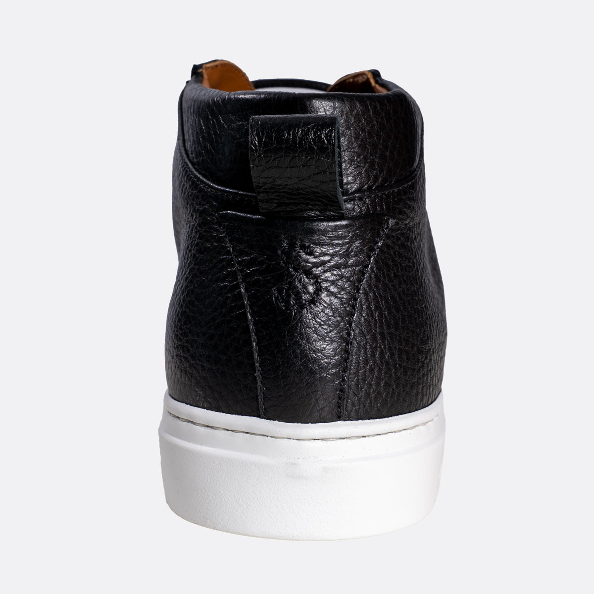 A black pebbled leather high-top sneaker shown from the back, featuring a thick white rubber sole and a small brown pull tab at the collar, set against a plain light gray background. Oliver Sweeney Sneakers available at Sakks Menswear in Southampton.