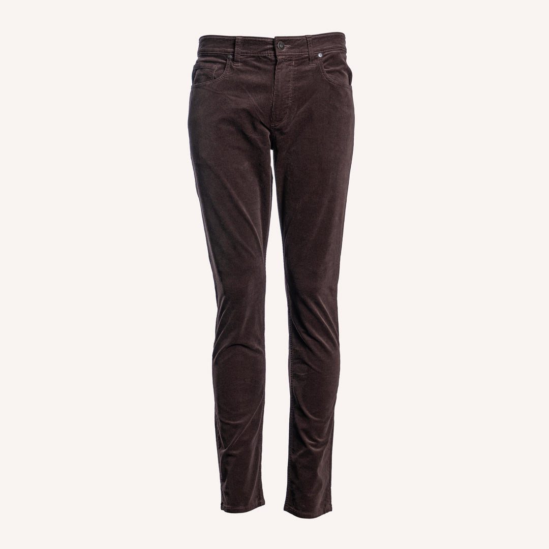 Dark brown corduroy slim-fit jeans shown on a clean, solid off-white background. PAIGE Jeans available at Sakks Menswear in Southampton.